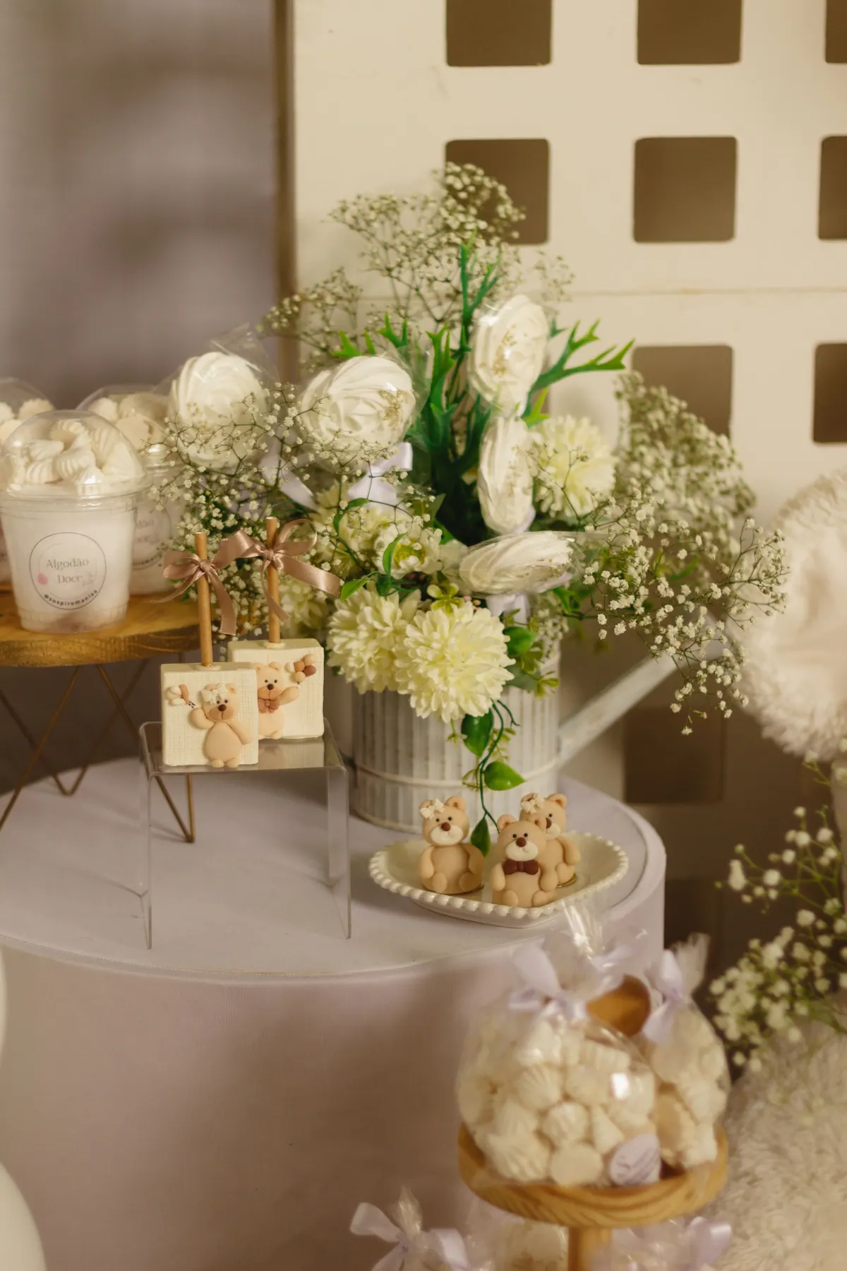 A tall floral centrepiece on a reception table with candles.